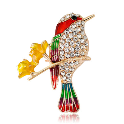 Front product view of the bird brooch pin in gold and red
