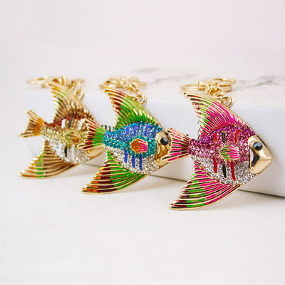 Three colorful rhinestone fish keychains displayed together on a white surface.