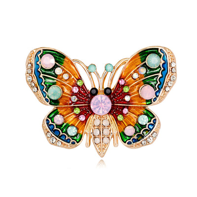 Front product view of the butterfly brooch pin in gold and red
