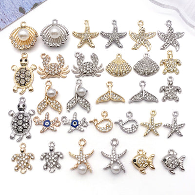 Metallic seahorse and turtle charms arranged on a light background