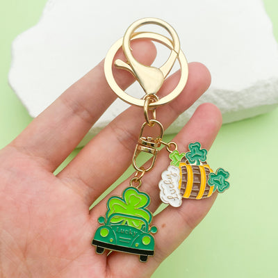 Image 1 showing a person holding a keychain with a green car.