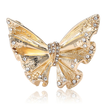Front view of the textured butterfly brooch showing an open-wing butterfly with crystal edges and textured panels