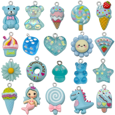 Blue bear and heart charms arranged on a light background