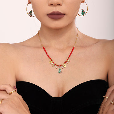 Model wearing gold red-bead Christmas tree charm necklace