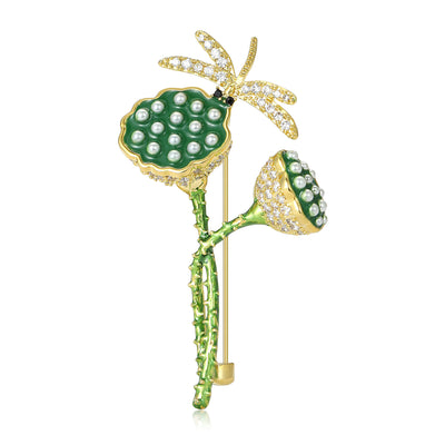 Front view of green lotus pod dragonfly brooch against a white background.