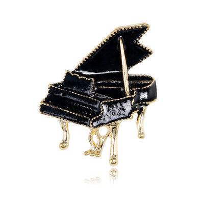 Front product view of the piano brooch pin in black and gold