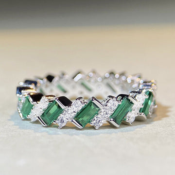 Green And Clear Baguette Woven Eternity Band In Silver Tone