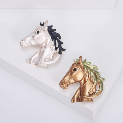 Front view of the horse head brooch showing a sculpted horse head with a contrasting mane