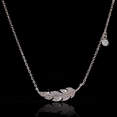 Front view of crystal leaf bar pendant necklace in silver tone with clear crystal details