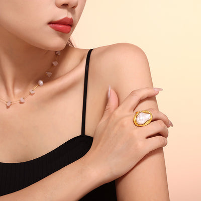 Model wearing gold irregular pearl ring with black tank top