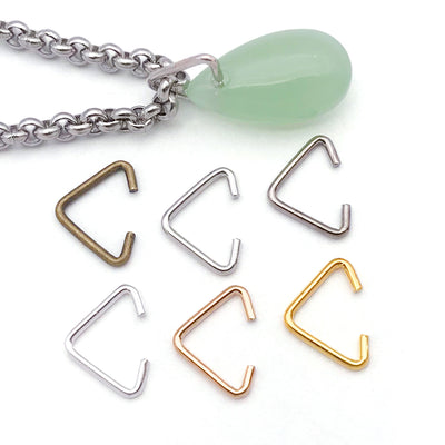 Metallic connector clasp jewelry findings arranged on a light background