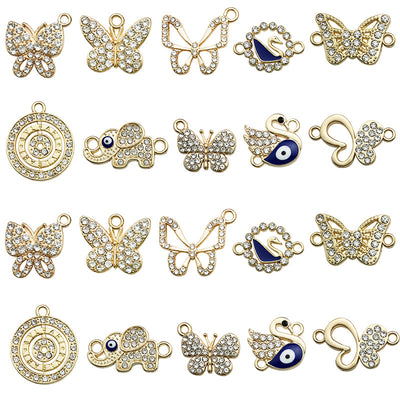 Yellow butterfly and elephant charms arranged on a light background