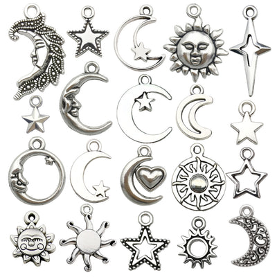 Silver-tone sun and moon charms arranged on a light background