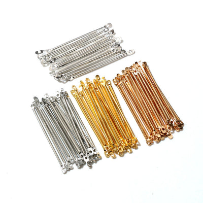 Overview of straight narrow connector bars with a loop at each end in silver, gold, copper, and pale rose tones