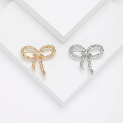 Front view of minimal open bow silhouette with a lightly textured surface