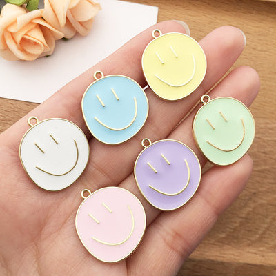 Gold-tone cake charms arranged on a light background