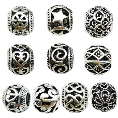 Metallic spacer bead beads arranged on a light background