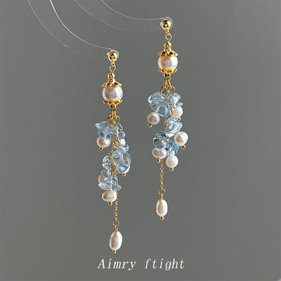 Gold pearl blue glass crystal long tassel earrings on gray background