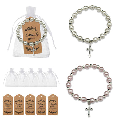 White and pink cross charm bracelets shown with organza bags and brown thank-you tags.