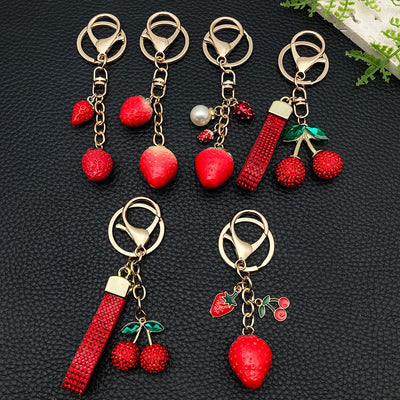 Overview showing the available color and design variations of the red rhinestone cherry and strawberry metal keychain