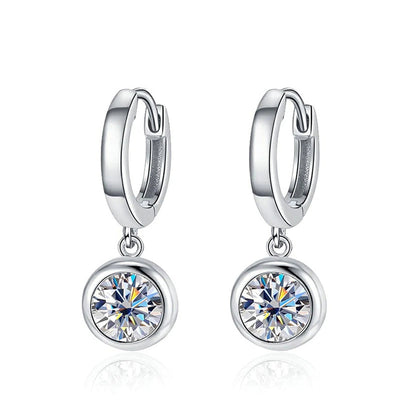 Pair of silver huggie hoops with round clear CZ drops on white