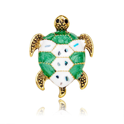 Front product view of the sea turtle brooch pin in green and gold