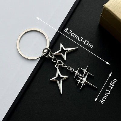 Main display of silver tone four point star cluster keychain