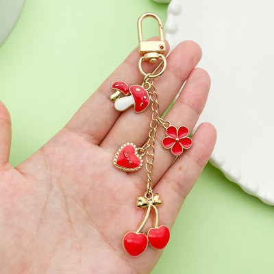 Image 1 showing a person holding a red and white heart shaped keychain.