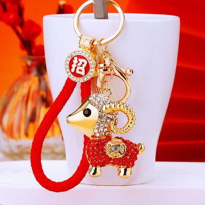 A styled group view shows the jeweled sheep keychain and its attached hardware.
