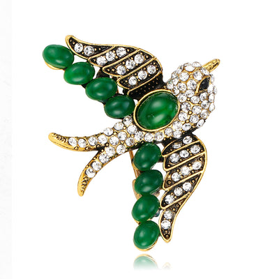 Front product view of an emerald and diamond brooch