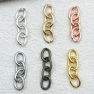 Metallic assorted shape charms arranged on a light background