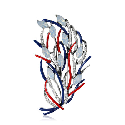 Front view showing the openwork feather brooch with crystal and enamel branches