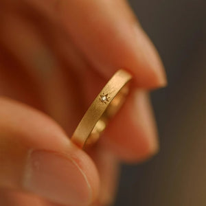 Matte Gold Tone Closed Band Ring With Tiny Starburst Crystal