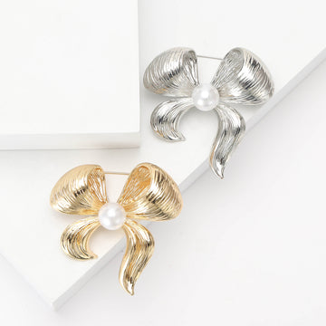Grooved Metal Bow Brooch With Pearl Center in Gold or Silver Tone