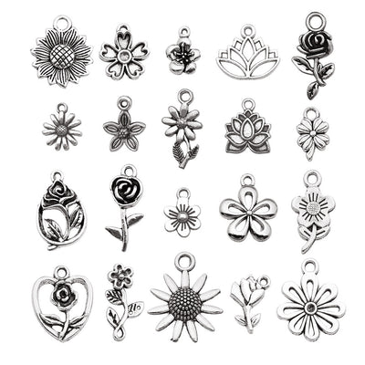 Antique silver sunflower charms arranged on a light background