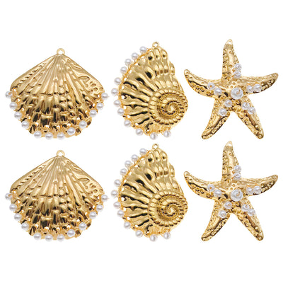 Gold-tone seashell and starfish charms arranged on a light background