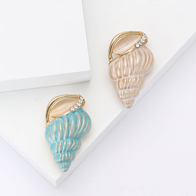 Front product view of the ridged conch shell in pastel enamel with a short crystal-trimmed rim brooch