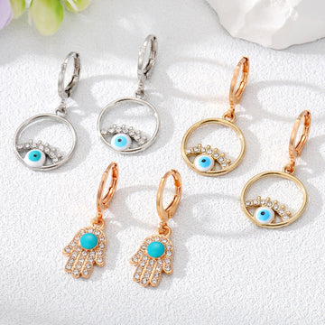 Gold Tone Crystal Hamsa and Evil Eye Huggie Drop Earrings