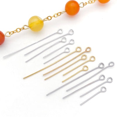 Front display of eye pins in three metal finishes and five lengths with visible colors and attached hardware