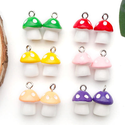 Colorful mushroom charms arranged on a light background