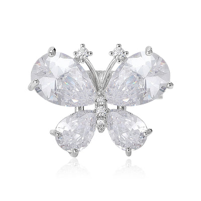 Front view of the clear crystal butterfly brooch in two metal tones with polished metal detail on a white background