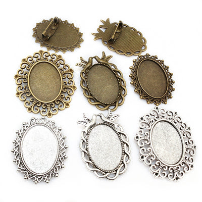 Ornate Oval Cabochon Brooch Bezel Settings in Six Styles, grouped overview on a plain background