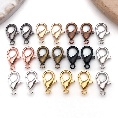 Metallic lobster clasp jewelry findings arranged on a light background