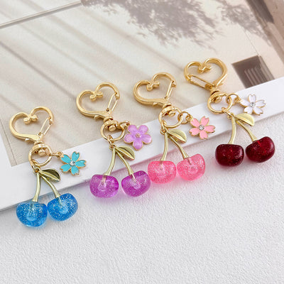 Red glitter resin cherry charm with white enamel flower accent
