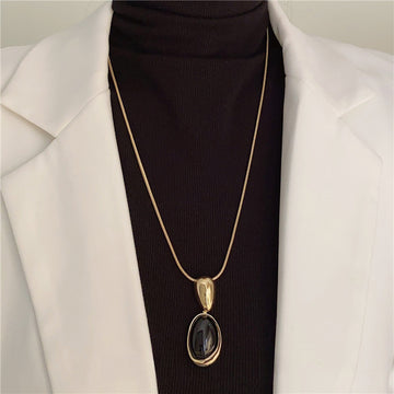 Sculpted Oval Black Pendant Necklace in Gold and Silver Tones