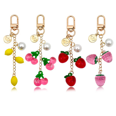 Image 1 showing a set of four charms with fruit and pearl.