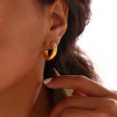 Gold C-shape crystal pave thick hoop stud earring on model ear