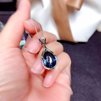 Product view showing blue iridescent pear-shaped pendant necklace