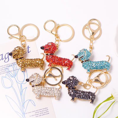 Five rhinestone dachshund keychains in gold red blue clear black