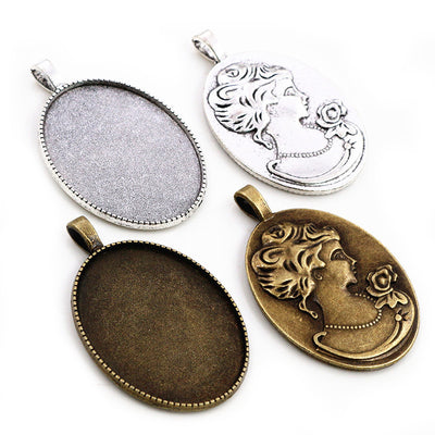 oval cabochon pendant trays arranged together on a white background